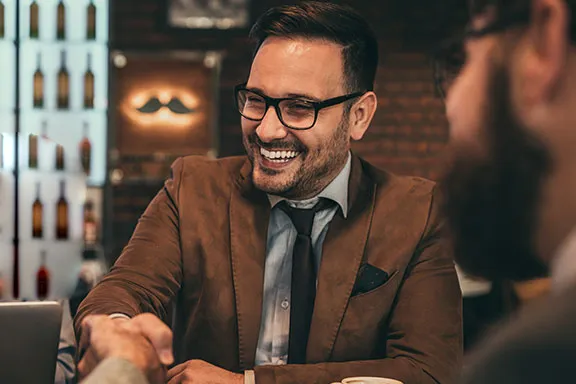 Smiling professional shaking hands at a business meeting